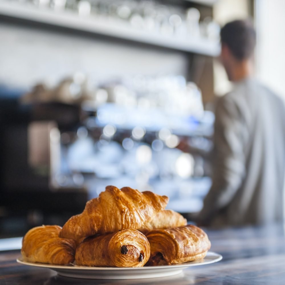 Croissants on plate on counter of a cafe