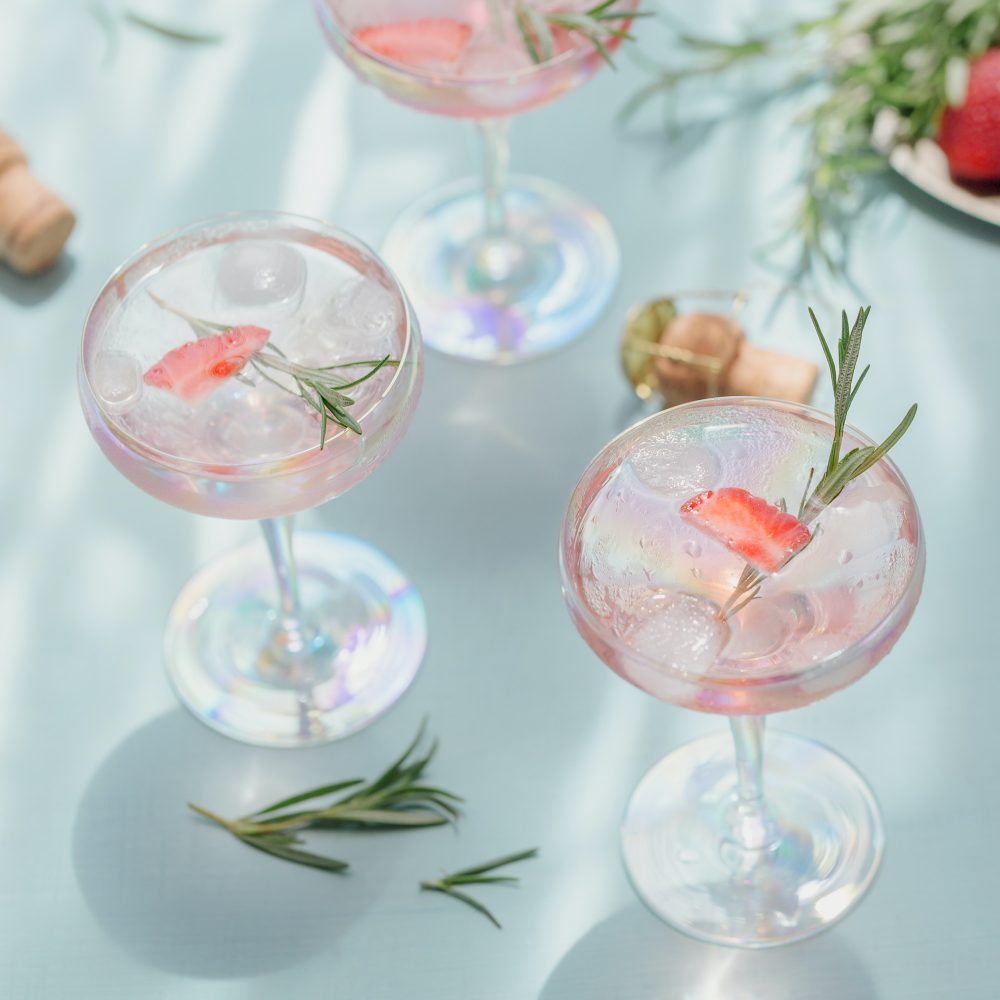 Summer pink cocktail with strawberry and ice cubes