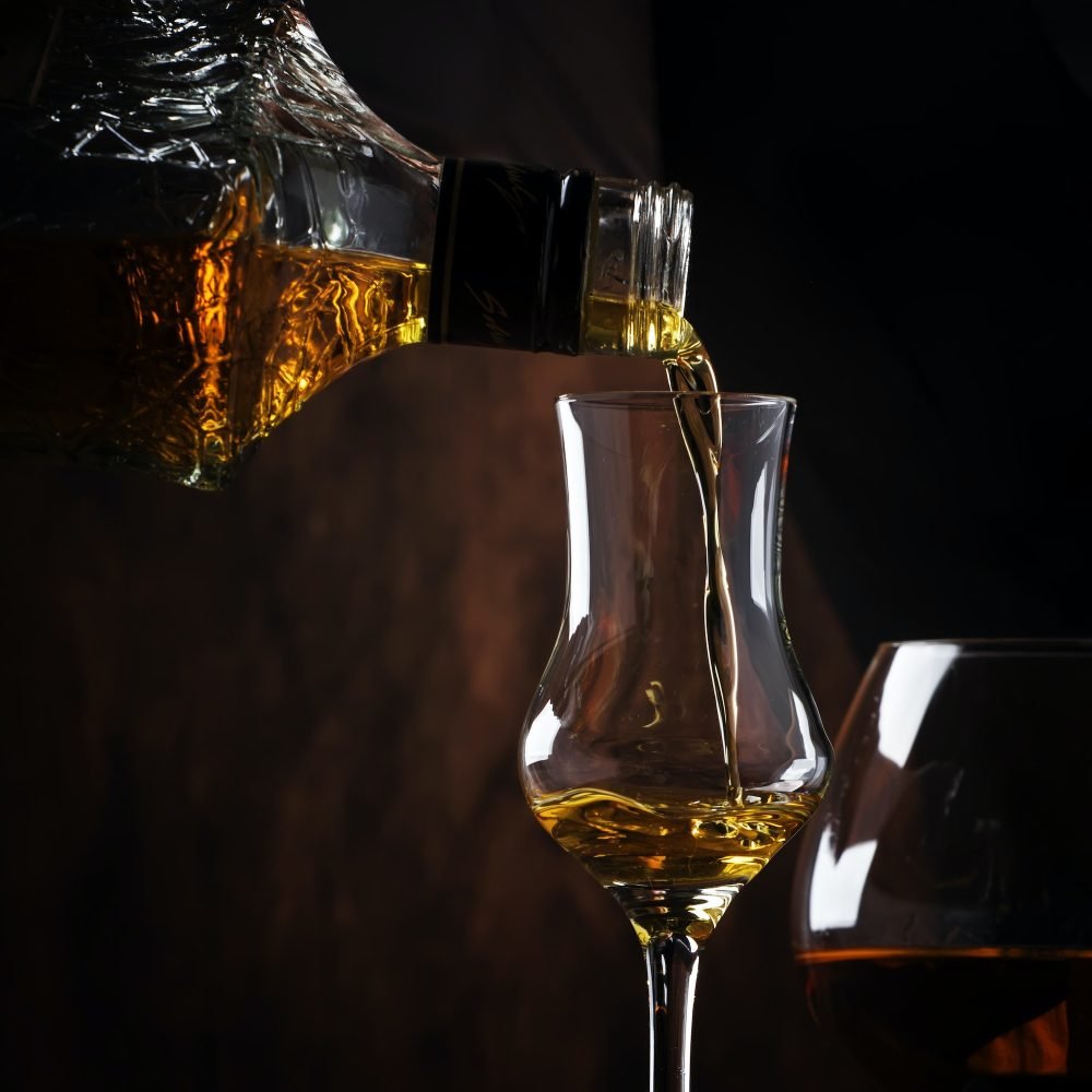 The bartender pours the liquor or brandy